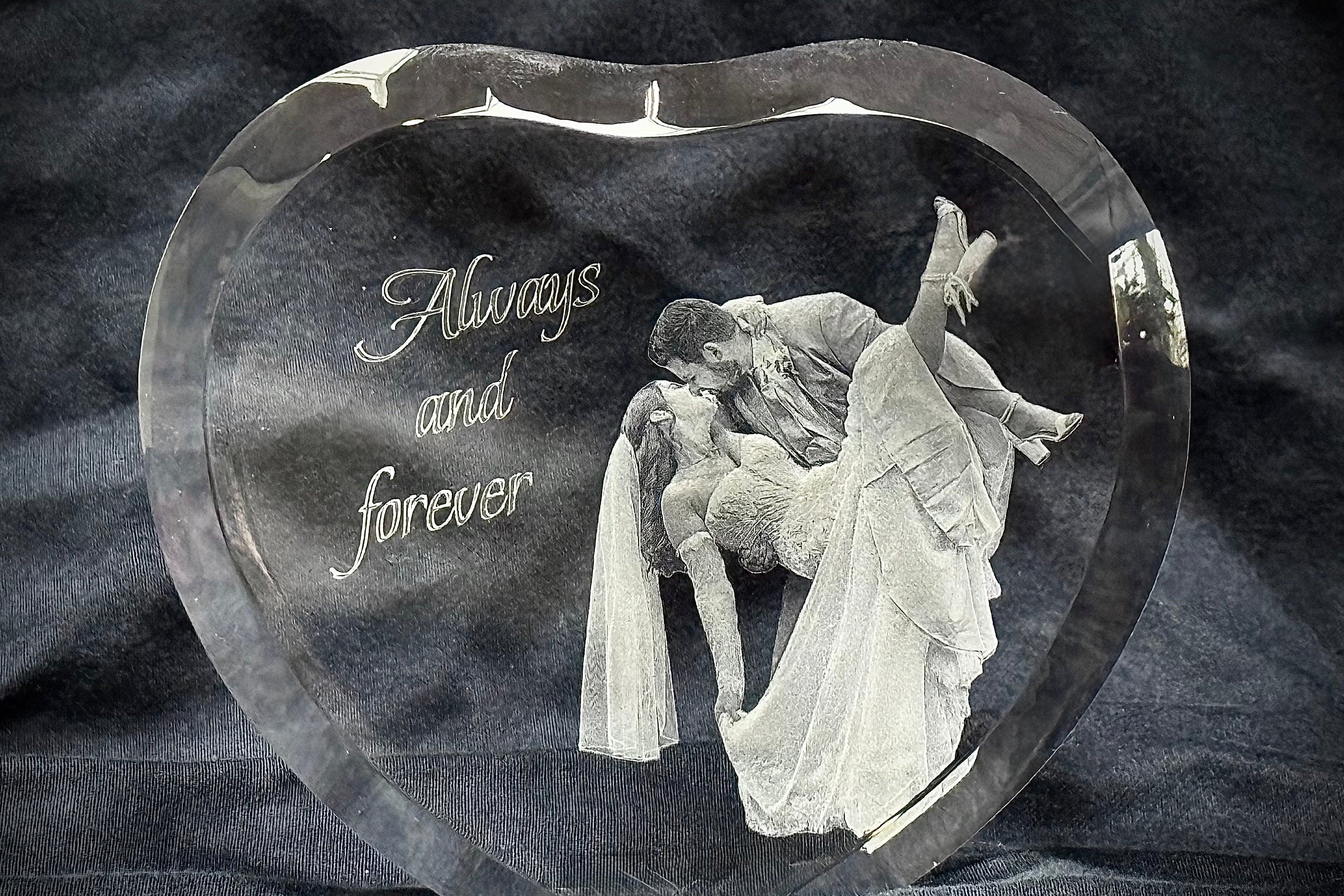Heart-shaped crystal with an engraved couple and 'Always and forever' text on a dark background